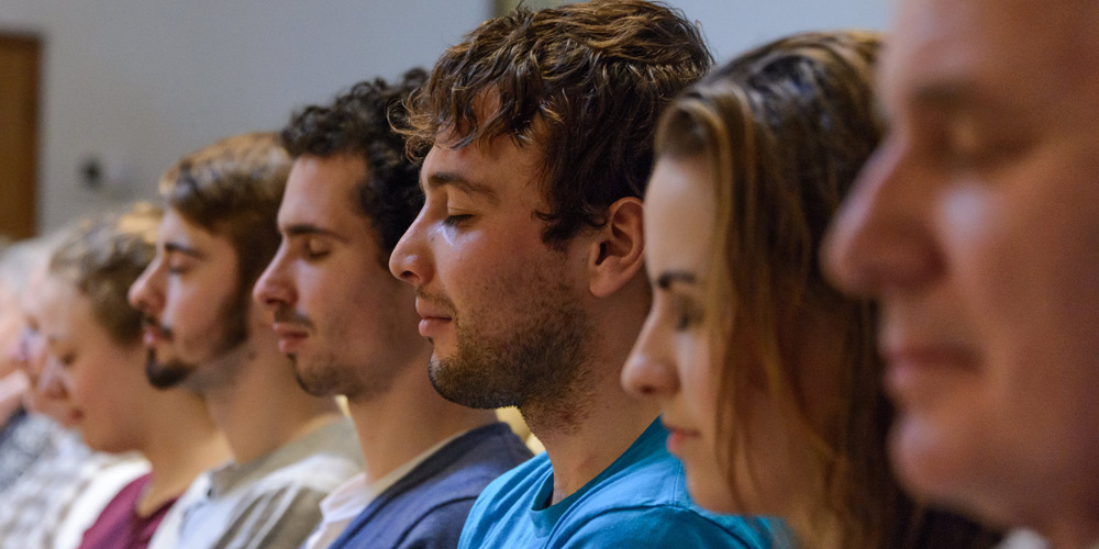 Corporate team meditating together